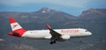 Tenerife, Spain December 10st, 2023. Airbus A320-214 Austrian Airlines flies in the blue sky.