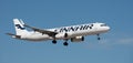 Finnair Airlines flies in the blue sky. Landing at Tenerife Airport