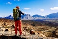 Tenerife, spain - January 10, 2022: A young adventurous man photographs a mountainous landscape