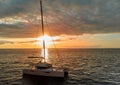 Lonely modern yacht in calm waters of open Atlantic Ocean at sunset