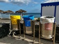 Tenerife, Spain - 17.05.2023: Three Colourful Metal Outdoor Recycling Bins near beach.