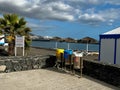 Tenerife, Spain - 17.05.2023: Three Colourful Metal Outdoor Recycling Bins near beach.