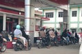 Tenggarong, Indonesia, December 2023, Scooters bike queue line waiting for petrol in Pertamina gas station