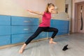Tennage girl doing fitness gymnastics at home. Gymnastics exercises video tutorial. Children`s activity in quarantine during