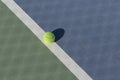 Tennis ball on blue and green hard court Royalty Free Stock Photo