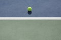 Tennis ball on blue and green hard court Royalty Free Stock Photo