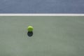 Tennis ball on blue and green hard court Royalty Free Stock Photo