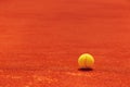 Tennis ball on clay court Royalty Free Stock Photo