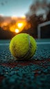 Tennis ball on a clay court at sunset