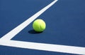 Tennis Ball on blue tennis court Royalty Free Stock Photo