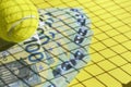 Tennis ball, euro banknotes on a yellow background. Investment in sports, prize money and betting concept. Copy space