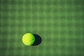 Tennis ball on the green court with net shadows Royalty Free Stock Photo