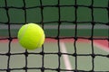 Tennis ball hitting to net on blur court background Royalty Free Stock Photo