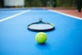 Tennis ball is laying in front of racket on opened tennis cort. Royalty Free Stock Photo