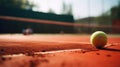 Tennis ball lies orange court. Yellow game ball close up. Sport court background