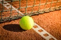 Tennis ball with line on a sand court Royalty Free Stock Photo