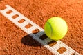 Tennis ball with line on a sand court Royalty Free Stock Photo