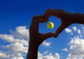 Tennis ball midair with cloudy sky above Royalty Free Stock Photo
