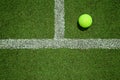 Tennis ball near the line on tennis grass court from top view. G Royalty Free Stock Photo