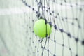 Tennis ball in net Royalty Free Stock Photo