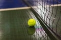 Tennis ball and net on wet ground after raining Royalty Free Stock Photo