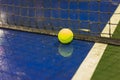 Tennis ball and net on wet ground after raining Royalty Free Stock Photo