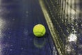 Tennis ball and net on wet ground after raining Royalty Free Stock Photo