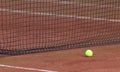 Tennis ball on the orange tenniscourt Royalty Free Stock Photo