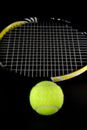 Tennis Ball and Tennis Racket on Black Background