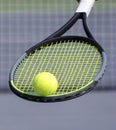 Tennis ball on tennis racket and blurred tennis court in background. Sport game and active healthy lifestyle concept Royalty Free Stock Photo