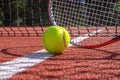 Tennis ball, racket and line on an outdoor court Royalty Free Stock Photo