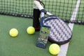 A tennis ball, a racket and a mobile phone with a put screen lie on a blue background. The concept of advertising a Royalty Free Stock Photo