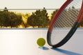 Tennis ball with racket on an outdoor sports court Royalty Free Stock Photo