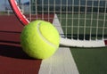 Tennis ball and racquet in background Royalty Free Stock Photo