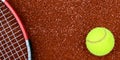 Tennis ball and racquet on a clay court Royalty Free Stock Photo