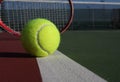 Tennis ball and racquet on court Royalty Free Stock Photo