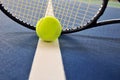 Tennis ball and racquet on a court line Royalty Free Stock Photo