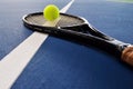 Tennis ball and racquet on a court line Royalty Free Stock Photo