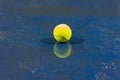 Tennis ball with reflection on ground after raining Royalty Free Stock Photo