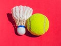 tennis ball and shuttlecock on red background. Royalty Free Stock Photo