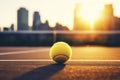 Tennis ball under late evening sunlight in a public tenniscourt in a big city Royalty Free Stock Photo