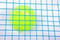 Tennis ball under a raquet