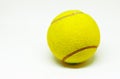 Tennis ball on white background. Game or match concept photo. Yellow felt ball with dark curve line and small shadow