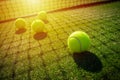 Tennis balls on grass court with sunlight Royalty Free Stock Photo