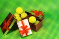 Tennis balls in holiday gift red boxes as present for Christmas, New Year, birthday on green color net background. Royalty Free Stock Photo