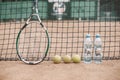 Tennis balls, racket and bottles of water on tennis court Royalty Free Stock Photo