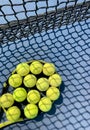 Tennis balls on the racket on hard court by the net. Tennis net shadows on tennis yellow balls. Royalty Free Stock Photo