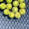 Tennis balls on the racket on hard court by the net. Tennis net shadows on tennis yellow balls. Royalty Free Stock Photo