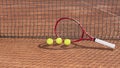 Tennis balls and racket on a red clay tennis court and net shadow. Sports background. Set for playing tennis. Copy space Royalty Free Stock Photo