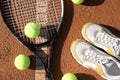 Tennis balls, racket and shoes on clay court, flat lay Royalty Free Stock Photo